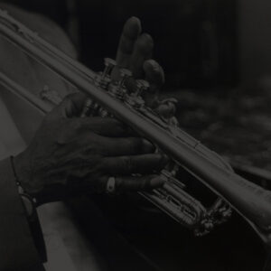 close-up of Louis Armstrong's hands on a trumpet