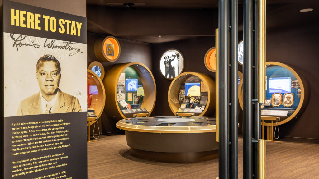 Group tour visitors explore the Louis Armstrong Center, home to the landmark Here to Stay permanent exhibition